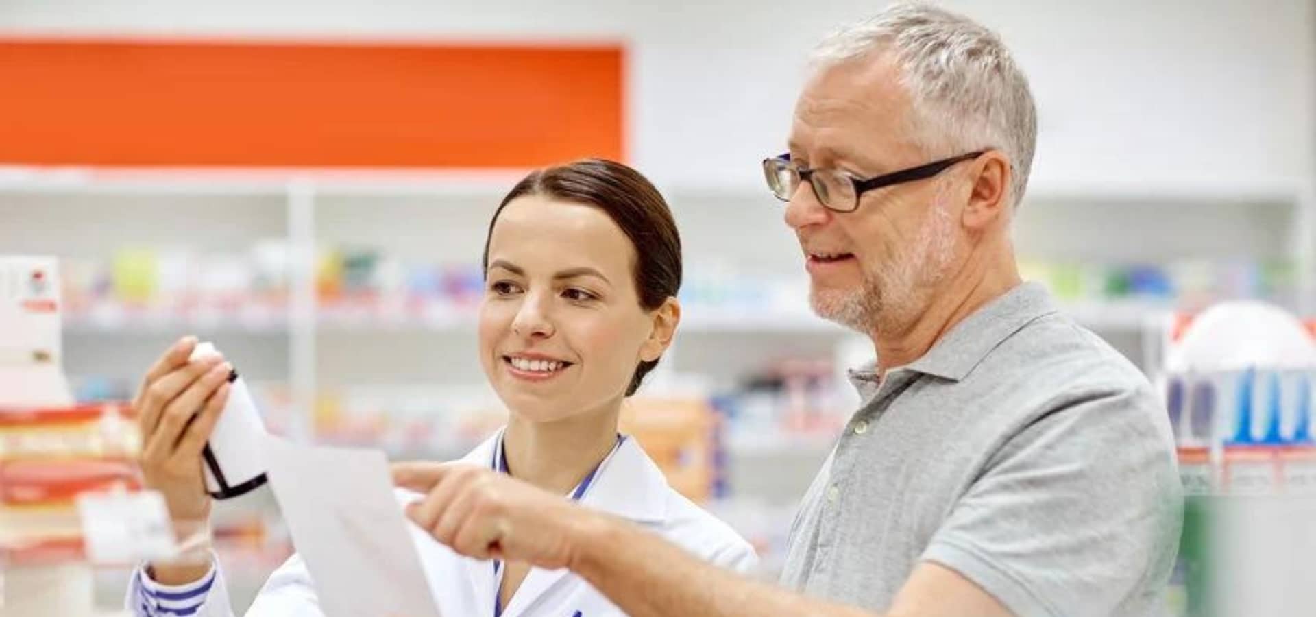 two person looking at a medical prescription